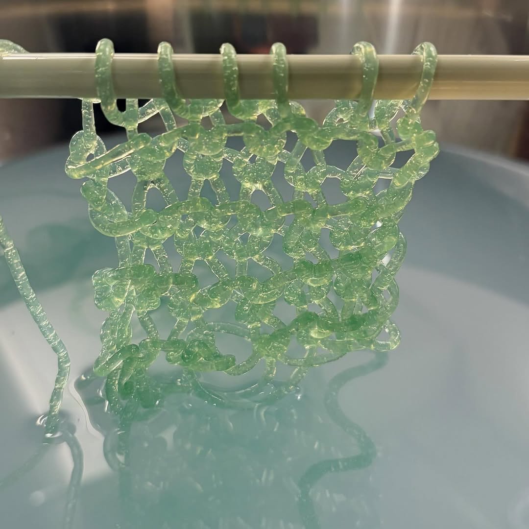 Hand-crocheted bioyarn drying over water